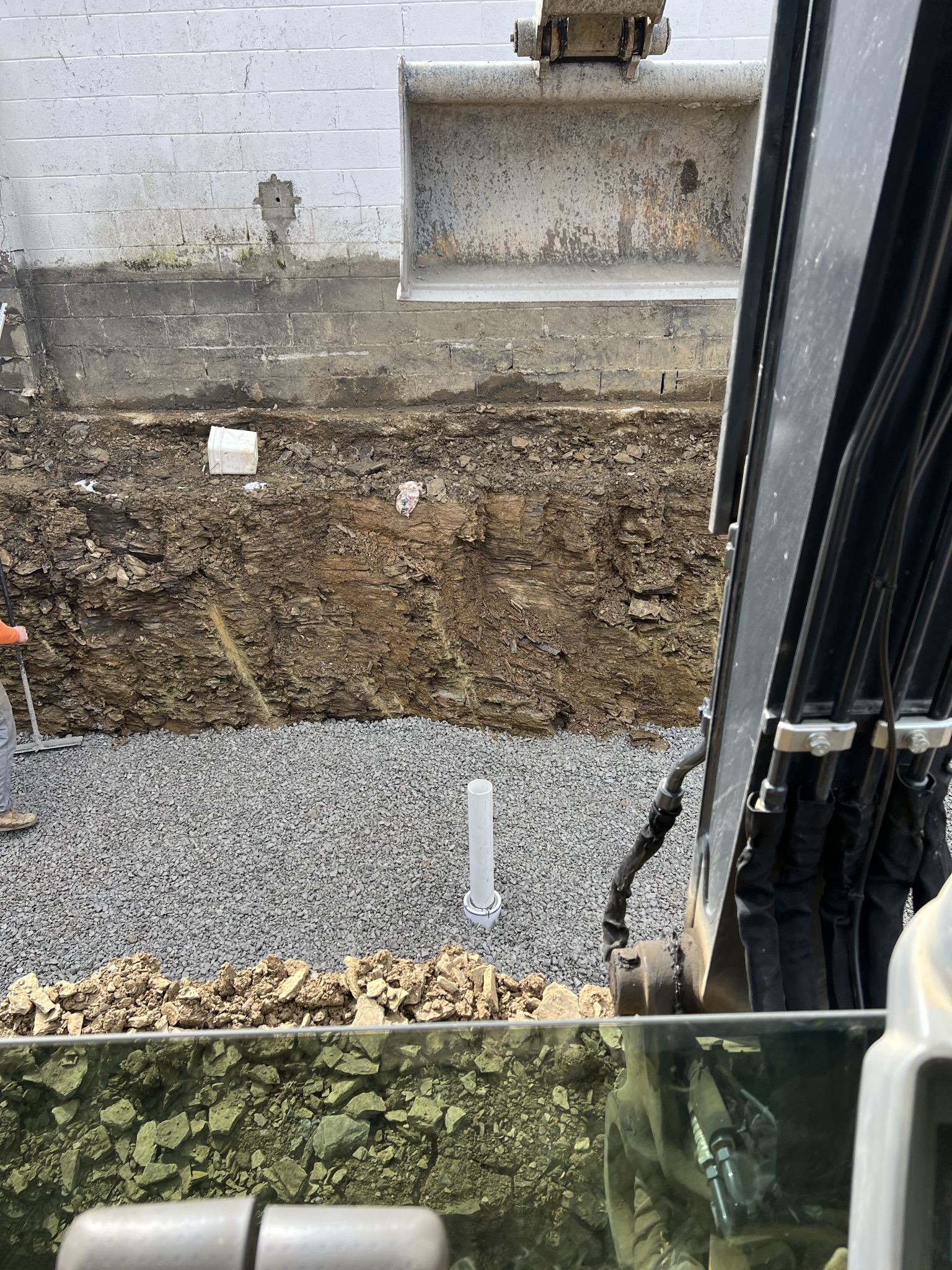 Gravel sub-base placed with plumbing rough-in stub