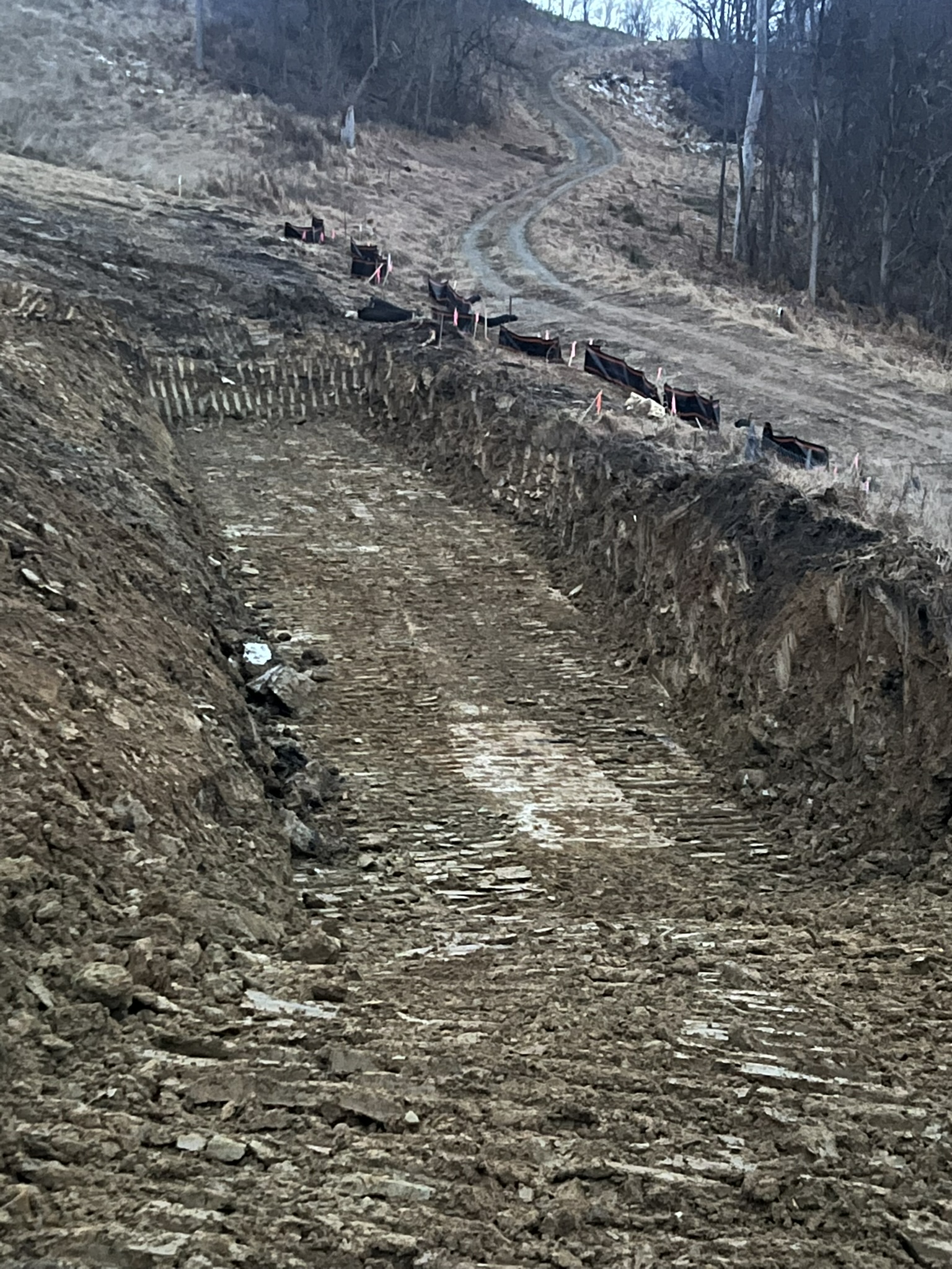 Access road cut with silt fence and erosion control installed