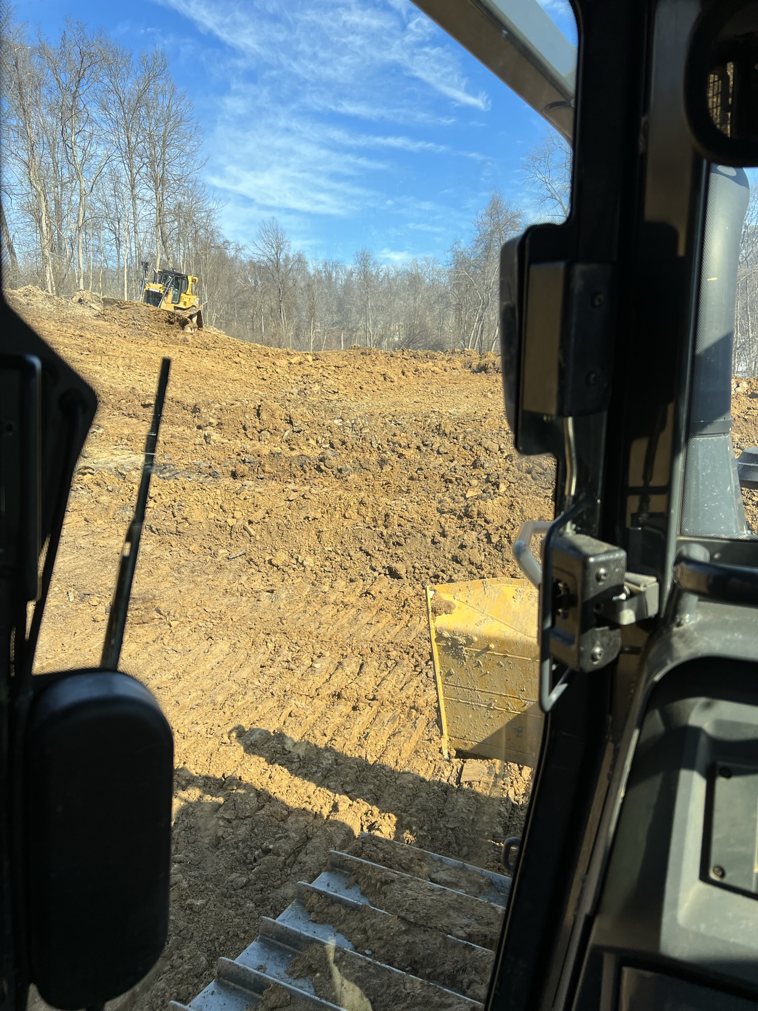 Dozer pushing home pad cut from inside cab