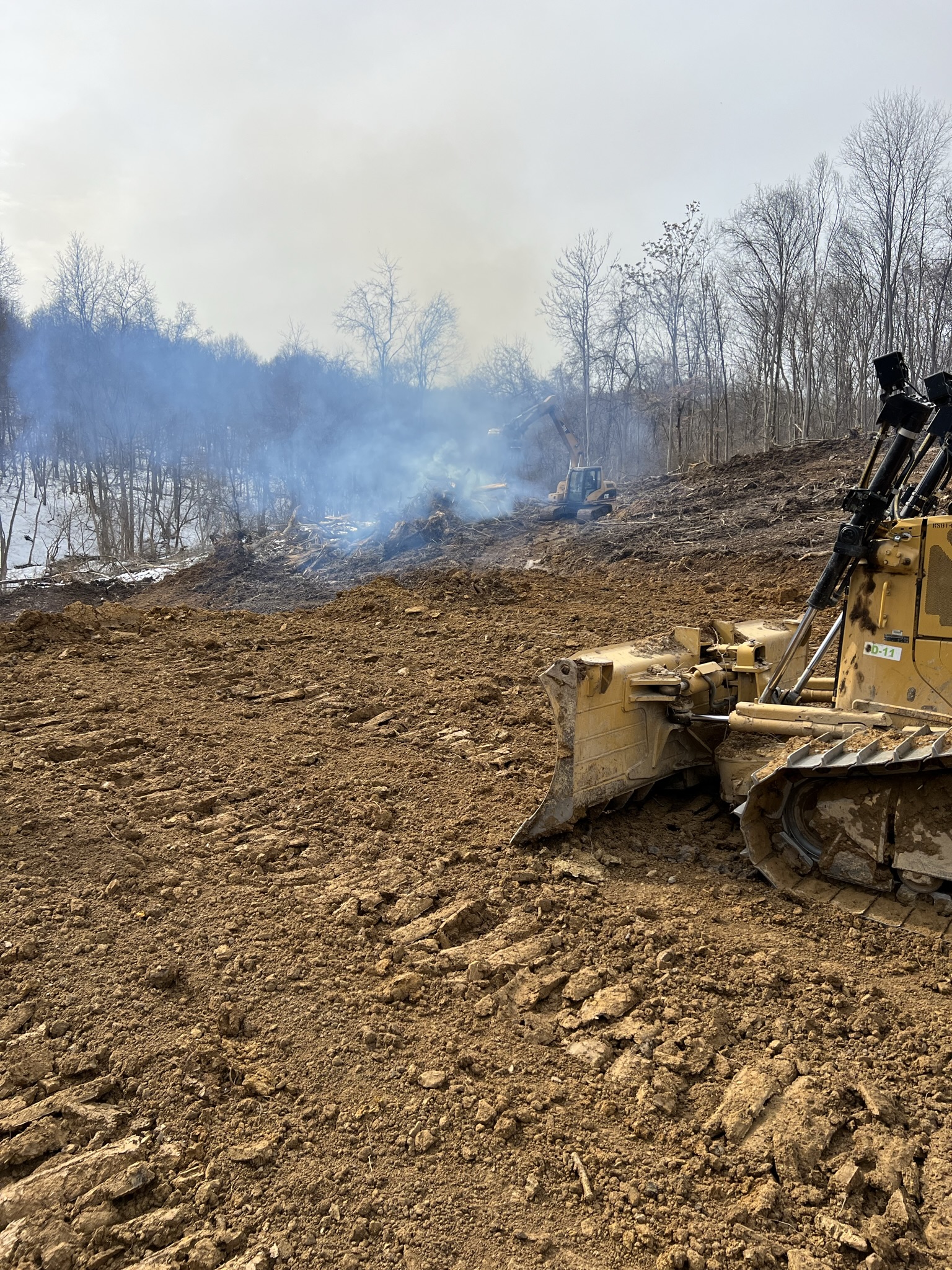 CAT D-11 dozer pushing massive home pad excavation