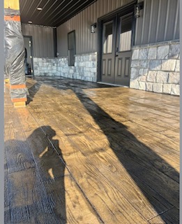 Stamped concrete patio finished to look like a wood deck
