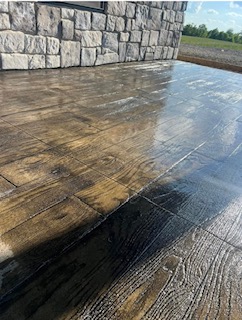 Stamped concrete deck-look patio near barn entrance
