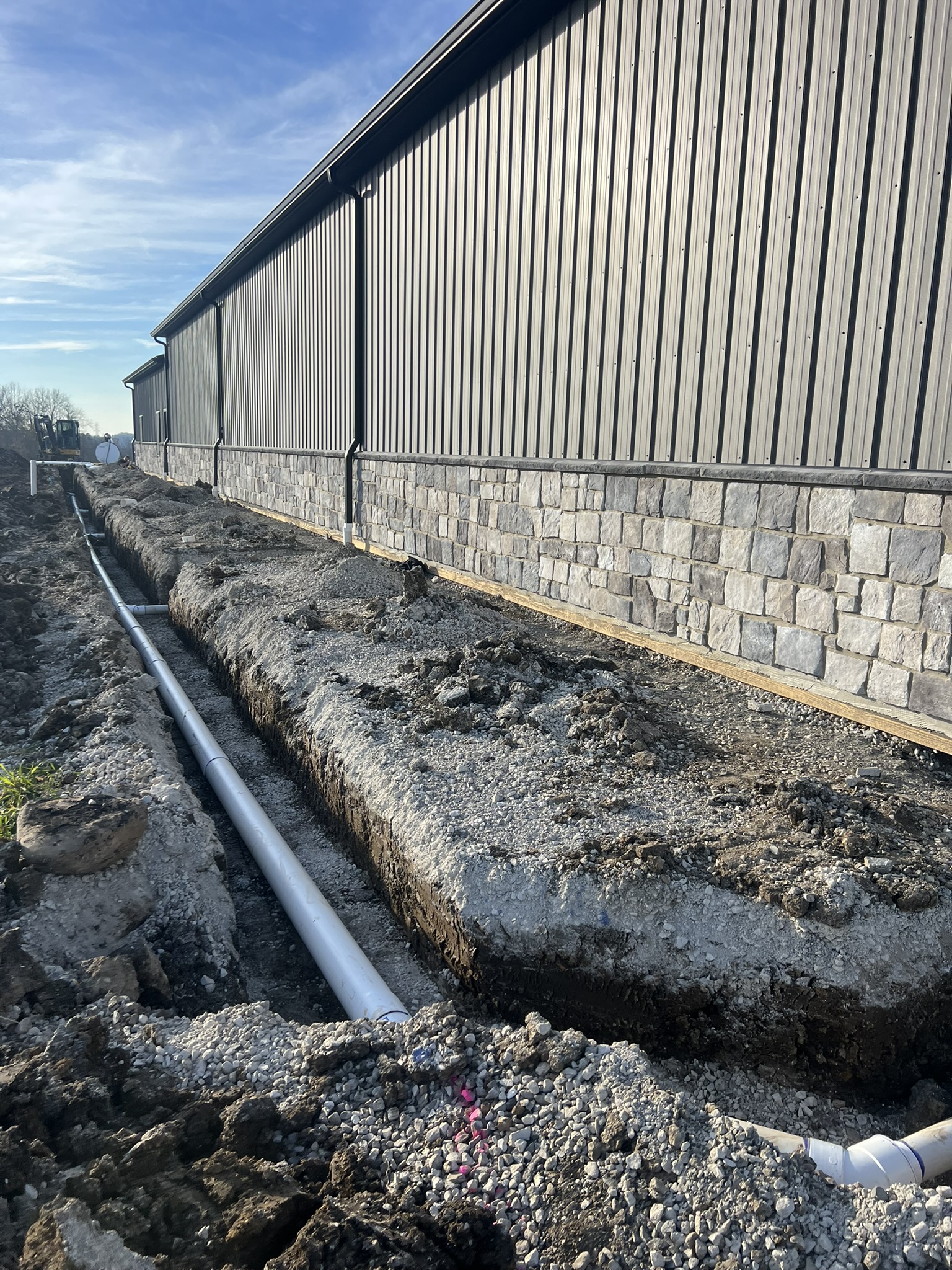PVC pipe run along full length of barn wall