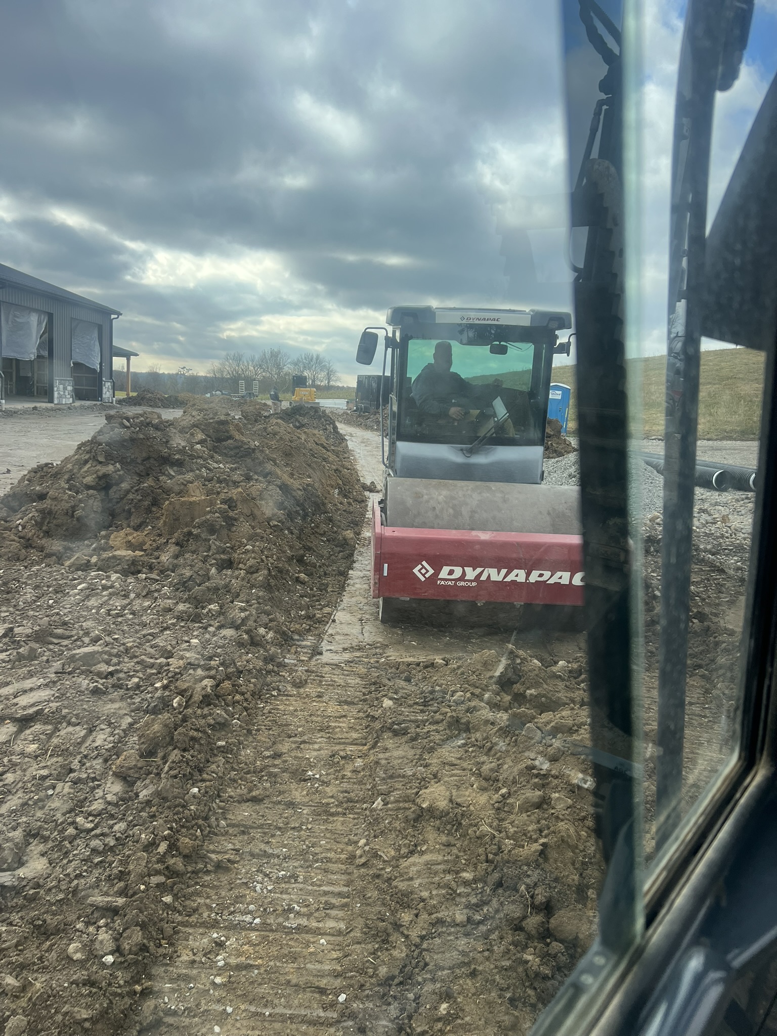 Dynapac roller compacting trench backfill