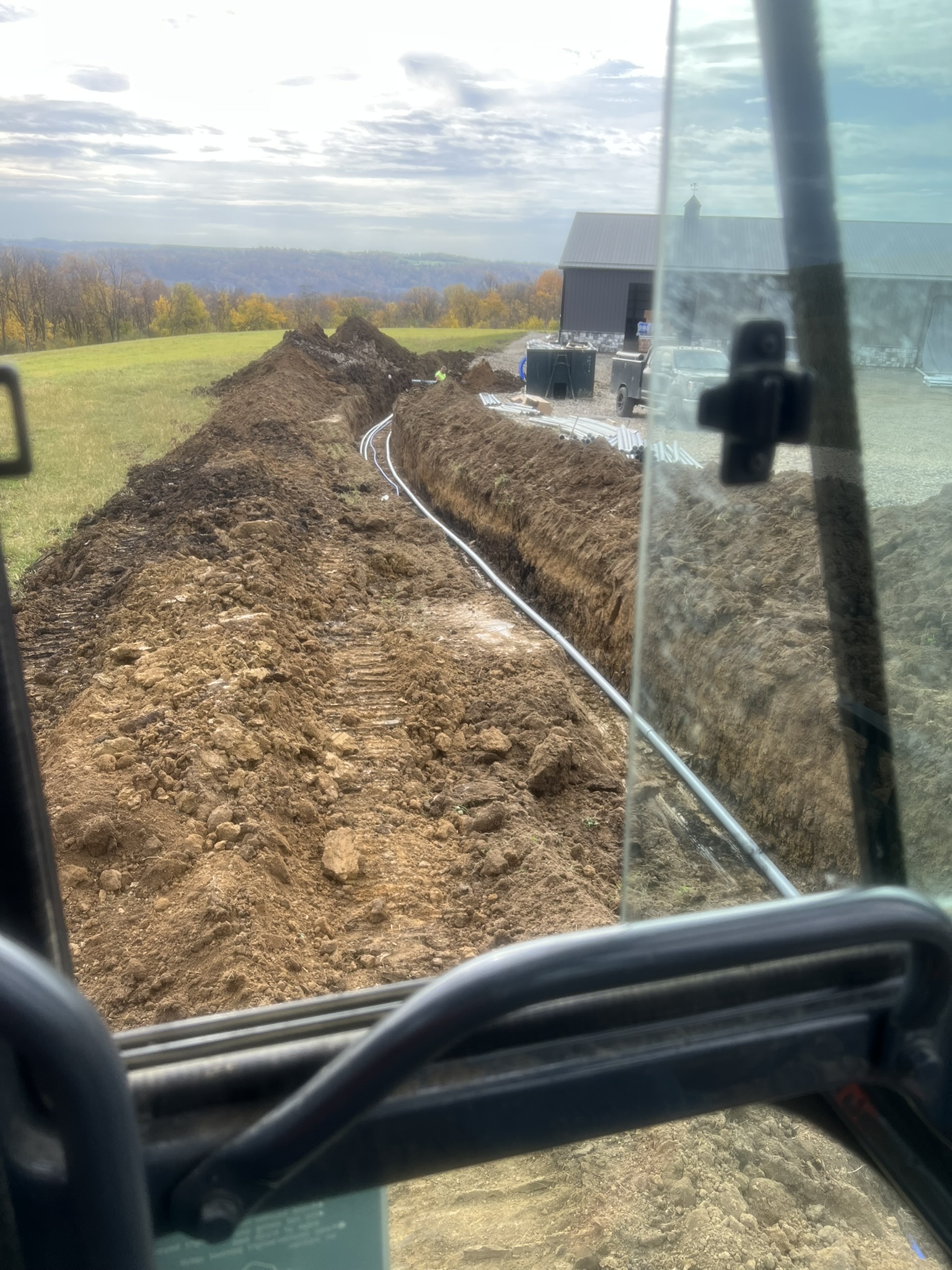 Cab view of conduit run heading toward barn