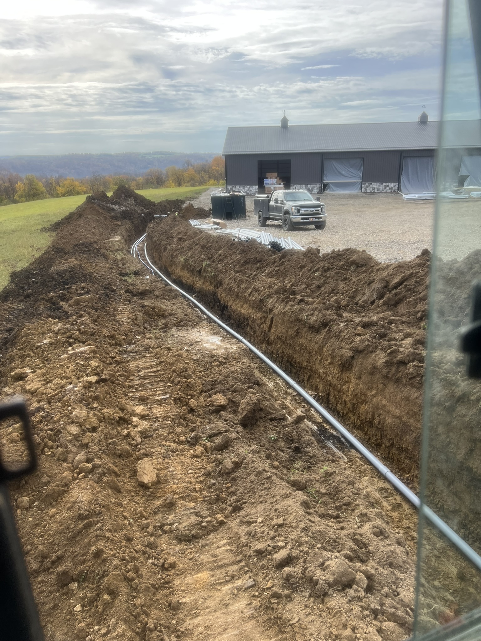 Full length of conduit trench toward barn