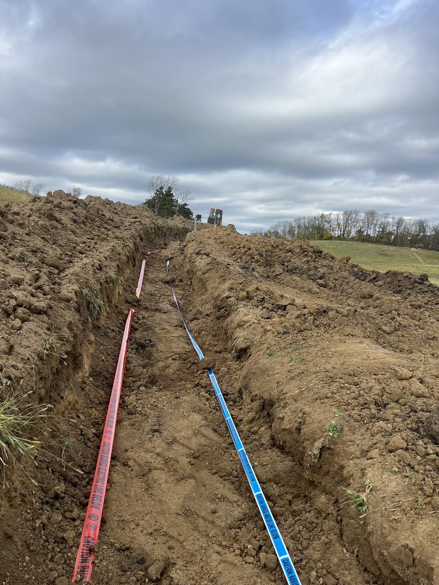 Trench with electric and water warning tape installed