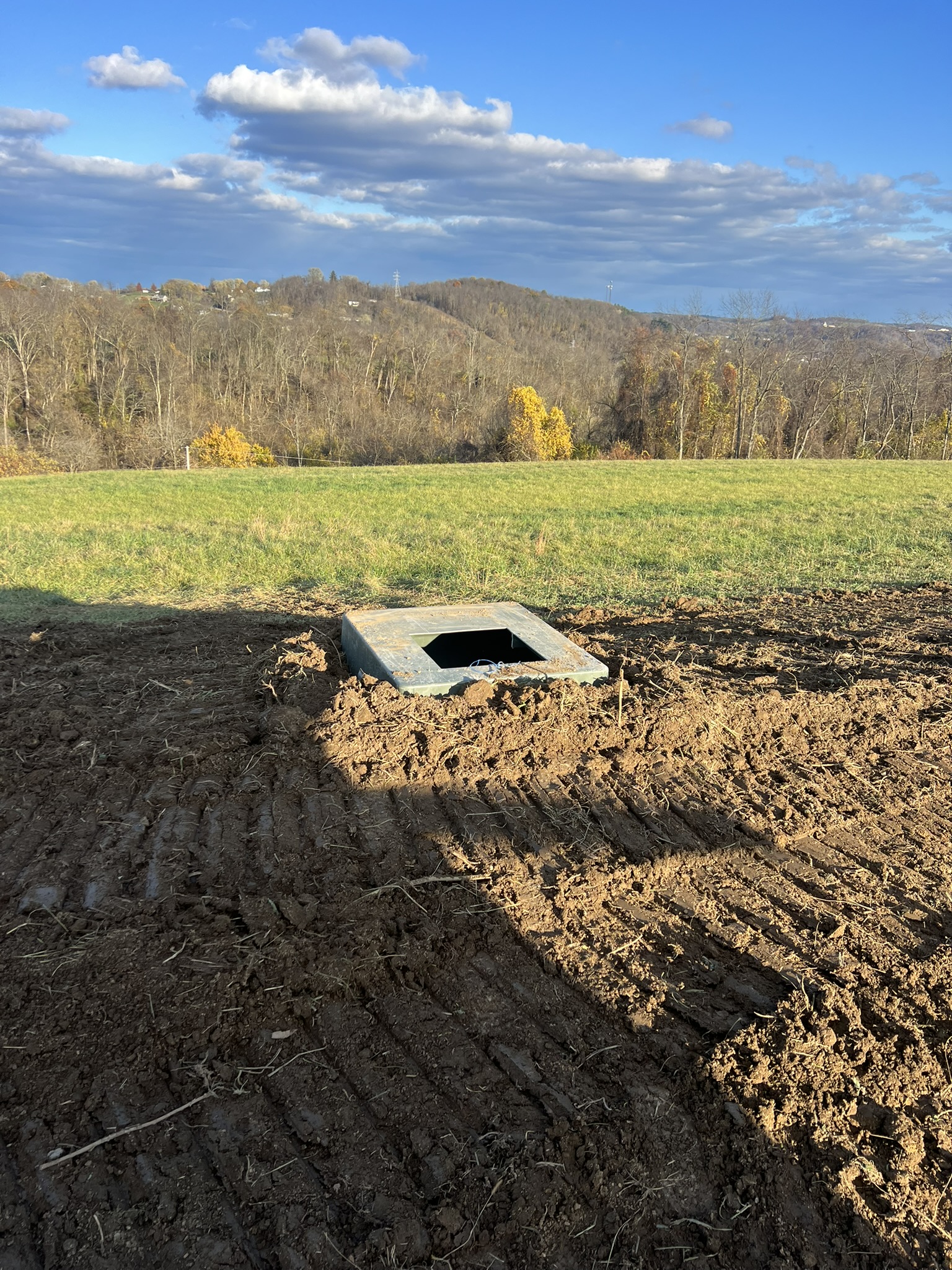 Precast meter vault set in field with fall foliage