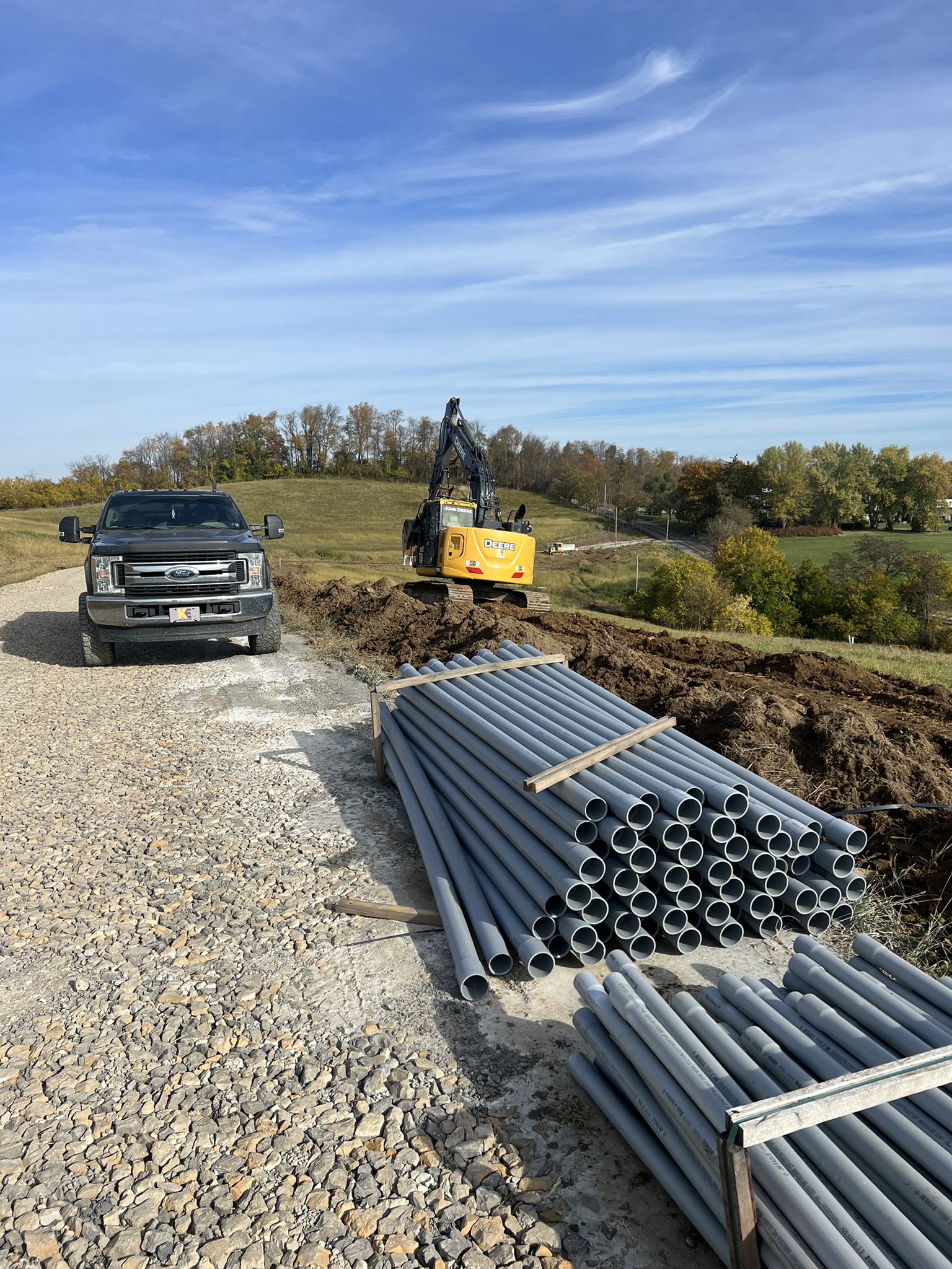 PVC pipe bundle staged on gravel road